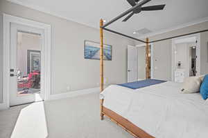 Bedroom featuring ceiling fan, light colored carpet, and crown molding