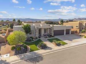 Southwest-style home featuring a mountain view and a garage