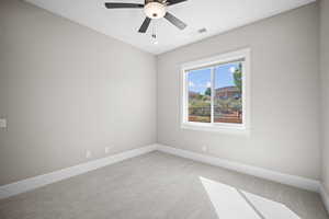 Empty room with carpet and ceiling fan