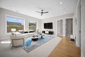 Living room featuring ceiling fan and light wood-type flooring