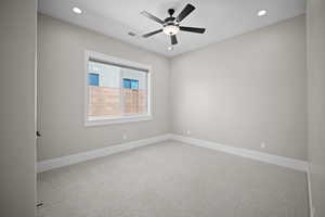 Spare room with carpet and ceiling fan