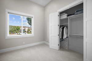 Unfurnished bedroom with a closet and light colored carpet