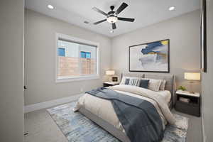 Carpeted bedroom with ceiling fan