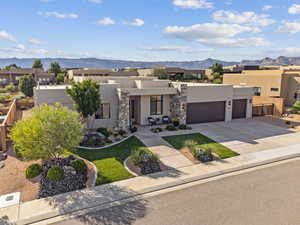 Pueblo revival-style home with a mountain view and a garage