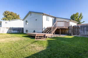 Rear view of property featuring a lawn