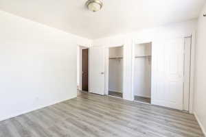 Unfurnished bedroom featuring a textured ceiling and light hardwood / wood-style floors