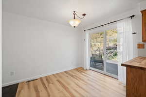 Unfurnished dining area with light LVP flooring