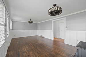 Interior space with crown molding, dark hardwood / wood-style flooring, and plenty of natural light