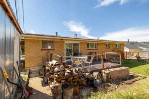 Rear view of house featuring a wooden deck