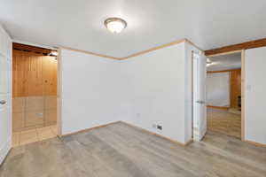 Unfurnished bedroom with crown molding, and light LVP floors