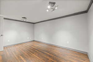 Bonus room with dark wood-type flooring