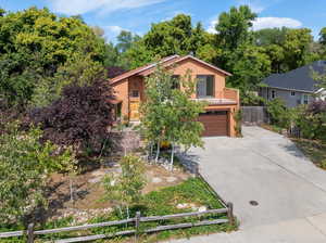 View of front of house featuring a garage and a balcony