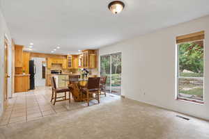 Dining room featuring light colored carpet