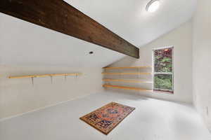 Interior space featuring lofted ceiling with beams