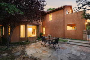 Back house at dusk with a patio