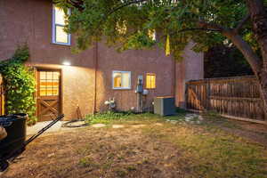 Rear view of property with central air condition unit