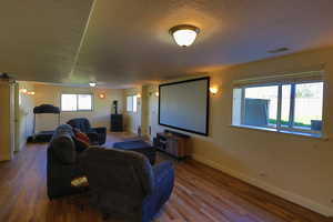 Interior space with a textured ceiling and hardwood / wood-style floors