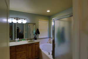 Bathroom featuring vanity and plus walk in shower