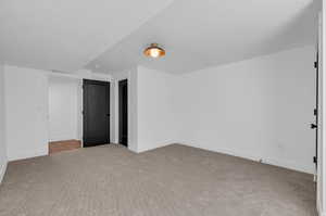 Unfurnished bedroom featuring a textured ceiling and light colored carpet