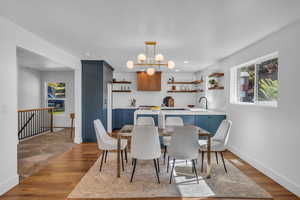 Dining area featuring dark hardwood / wood-style flooring, a chandelier, and sink