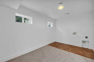 Spare room featuring wood-type flooring