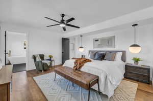 Bedroom with ceiling fan and wood-type flooring