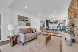 Living room featuring light hardwood / wood-style floors and an inviting chandelier