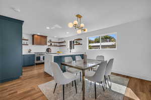 Dining room featuring dark hardwood / wood-style flooring, a chandelier, sink, and a textured ceiling