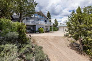 View of front facade with a garage and an outbuilding