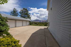 Exterior space featuring a mountain view, a garage, and an outbuilding