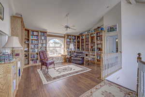 Sitting room featuring vaulted ceiling, dark hardwood / wood-style floors, and ceiling fan