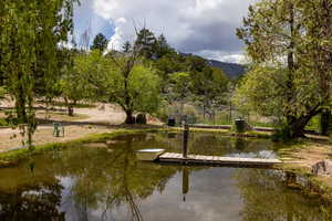 Surrounding community featuring a water and mountain view