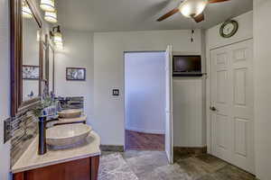 Bathroom featuring ceiling fan and vanity