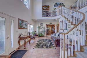 Tiled entrance foyer featuring high vaulted ceiling