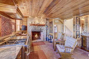 Kitchen featuring a fireplace, wood ceiling, high end stove, and tile patterned floors