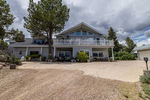 Back of house featuring a balcony and a patio area