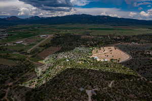 Birds eye view of property with a mountain view and a rural view