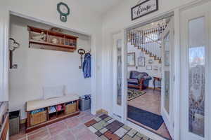 Mudroom with light tile patterned floors