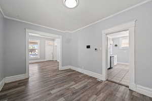 Spare room with dark hardwood / wood-style floors and ornamental molding