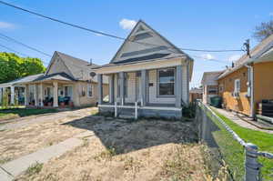 Bungalow-style house with cooling unit and a porch