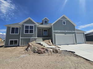 View of front of property featuring a garage and covered porch