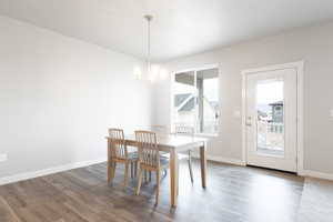 Dining room featuring an inviting chandelier and dark hardwood / wood-style flooring