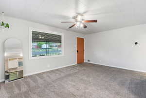 Spare room with ceiling fan and carpet