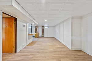 Corridor with light hardwood / wood-style floors