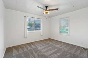 Spare room with carpet flooring and ceiling fan