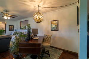 Office with ornamental molding, dark hardwood / wood-style floors, and ceiling fan