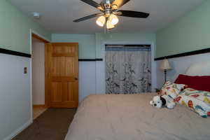 Carpeted bedroom with ceiling fan