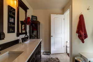 Bathroom featuring tile patterned flooring and double vanity