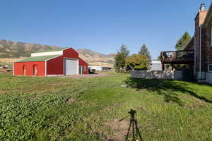 View of yard featuring a deck with mountain view