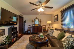 2nd Living room with dark wood-type flooring, ceiling fan, and crown molding